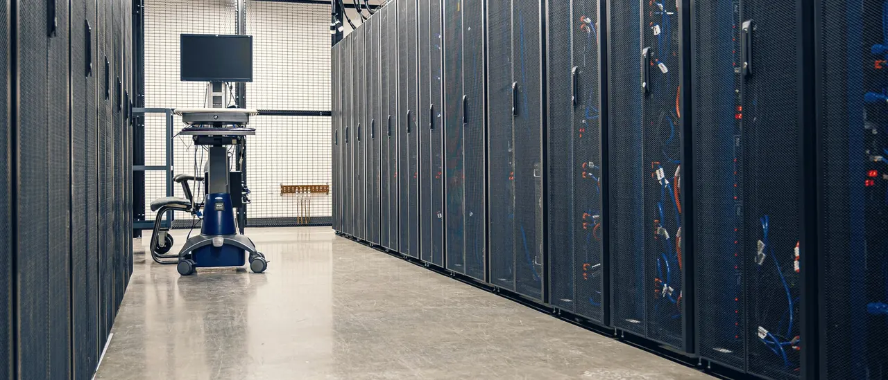 Rows of server cabinets in a data centre corridor